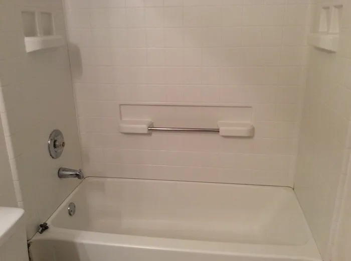 A bathtub and tiled surround cleaned by Sunshine Cleaning
